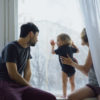 Why Is My Furnace Filter Soggy? Happy family with young cute daughter sitting on windowsill playing and looking in window at home in the morning